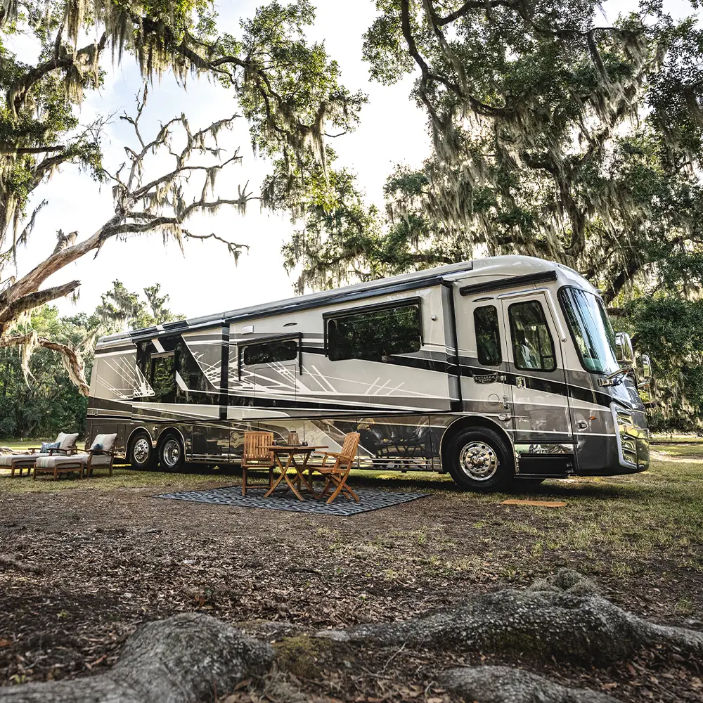 Entegra Cornerstone diesel pusher motorhome at a wooded campsite